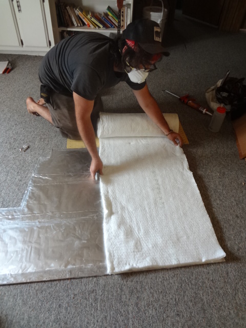 Attaching ceramic wool to cement board with dabs of silicone