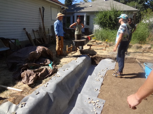 Trench is lined with landscape cloth, then 4" perforated corrugated drain pipe will be laid at the base.