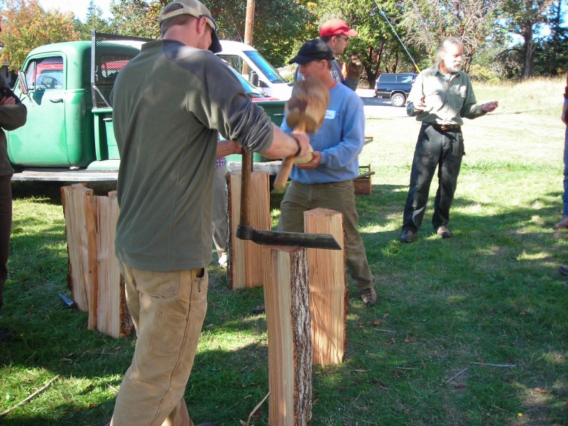 Using the froe with a wooden mallet to split the wood into smaller pieces